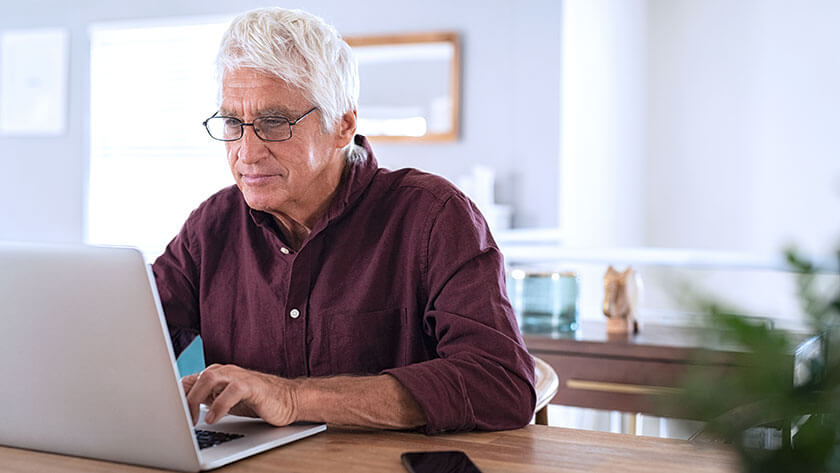 senior-man-using-laptop-at-home