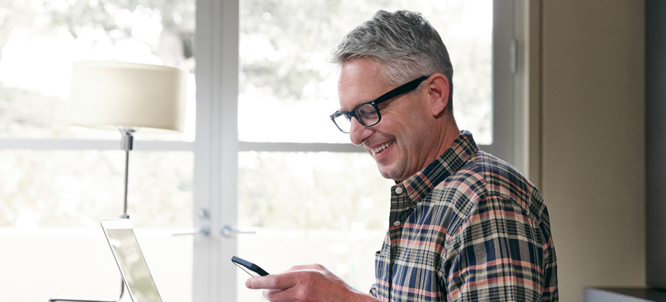 Mature male reading his phone