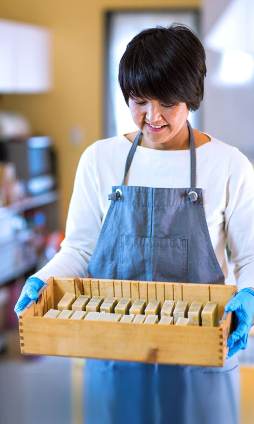 A woman makes soap to sell.