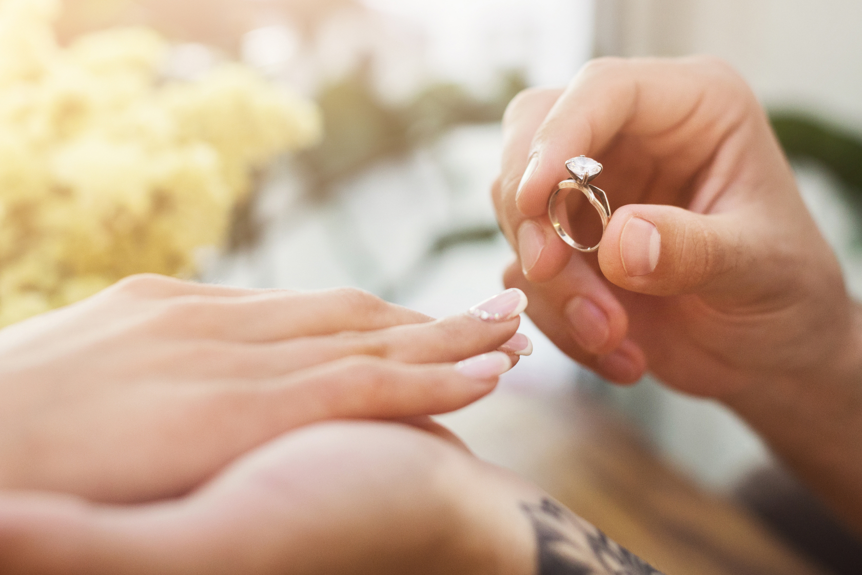 A person places a diamond engagement ring on their significant other's hand. Read about the legal matters you should take care of before you walk down the aisle.