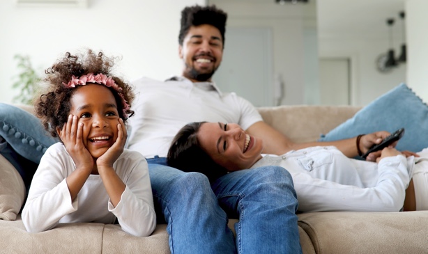 A young family spends time together on the couch.