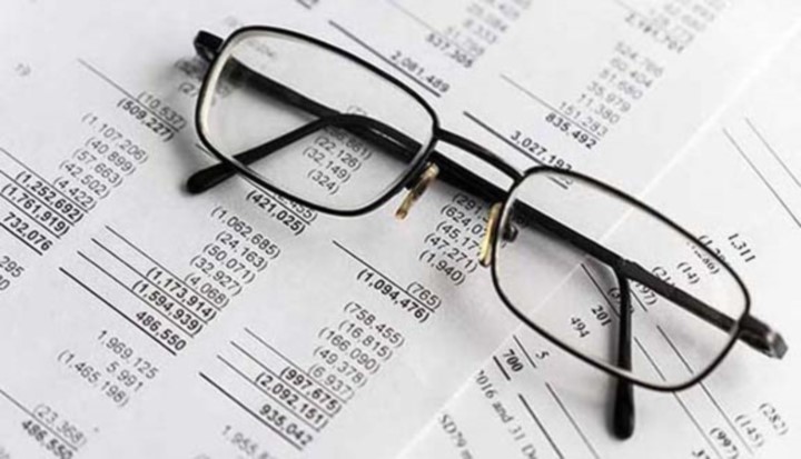A pair of glasses sitting on financial documents