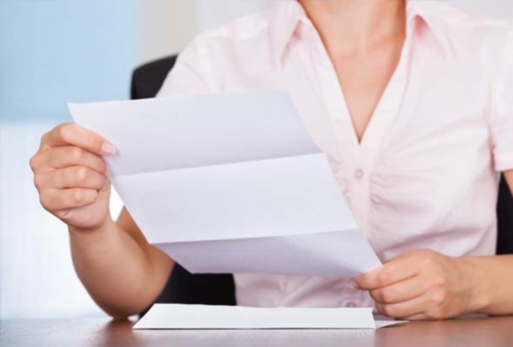 Woman holding a piece of unfolded paper