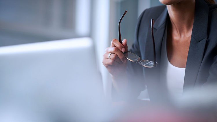 Woman removes glasses examining information