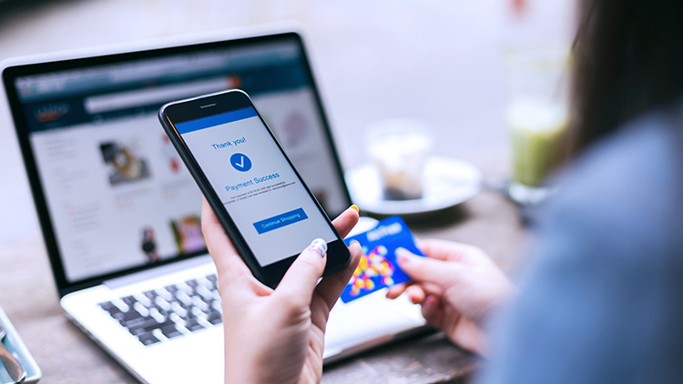 Woman holding phone making an online purchase