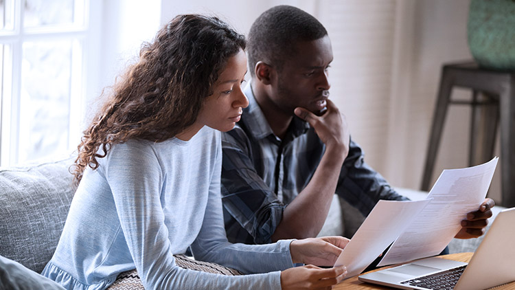 woman and man look over documents