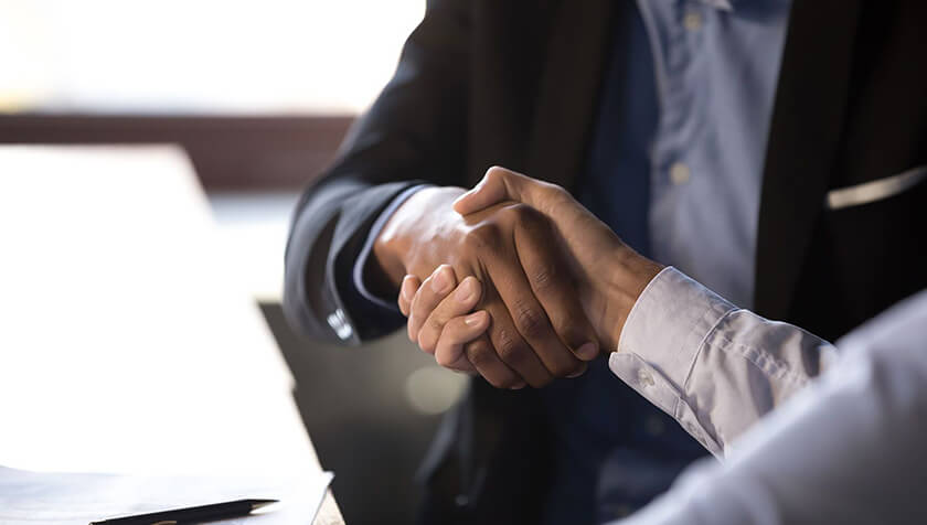 business people shaking hands after making a deal