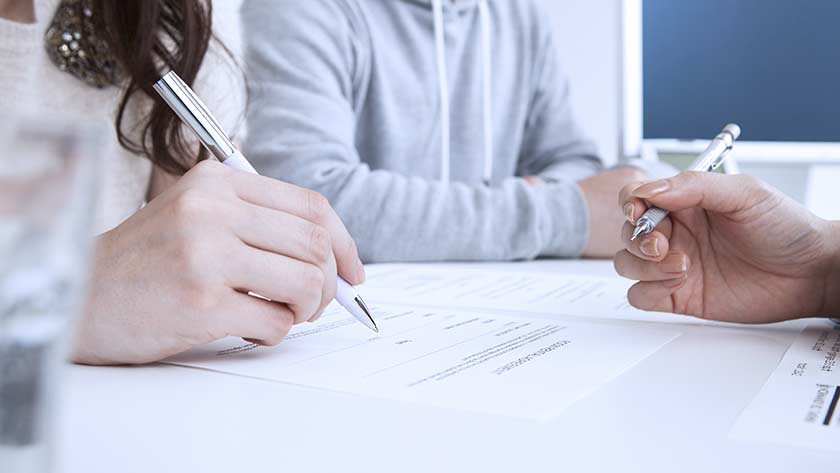 Couple signing documents