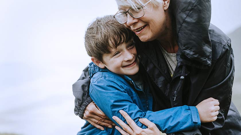 Grandmother hugs grandson