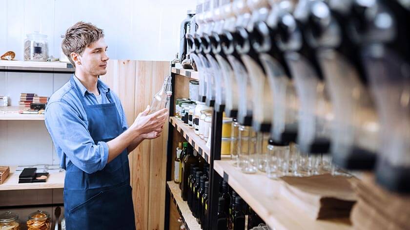 man-bottling-olive-oil-boutique in a warehouse