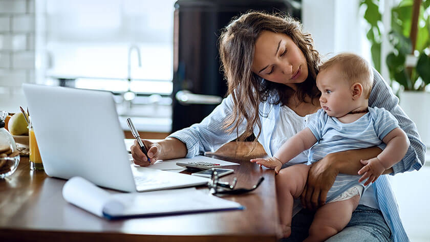mother-working-at-home-holding-baby