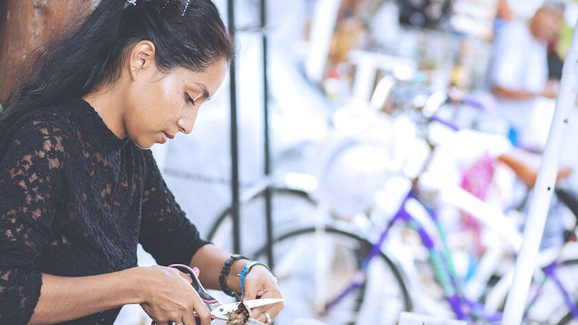 woman-cutting-in-bike-shop in black lace top