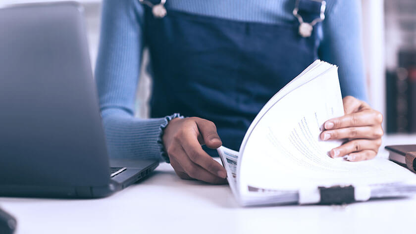 woman-looking-through-stack-of-documents