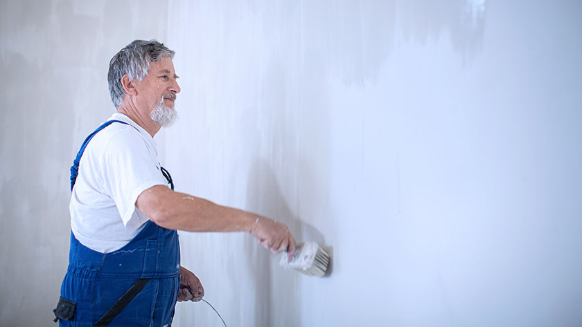 man-painting-inside-of-room