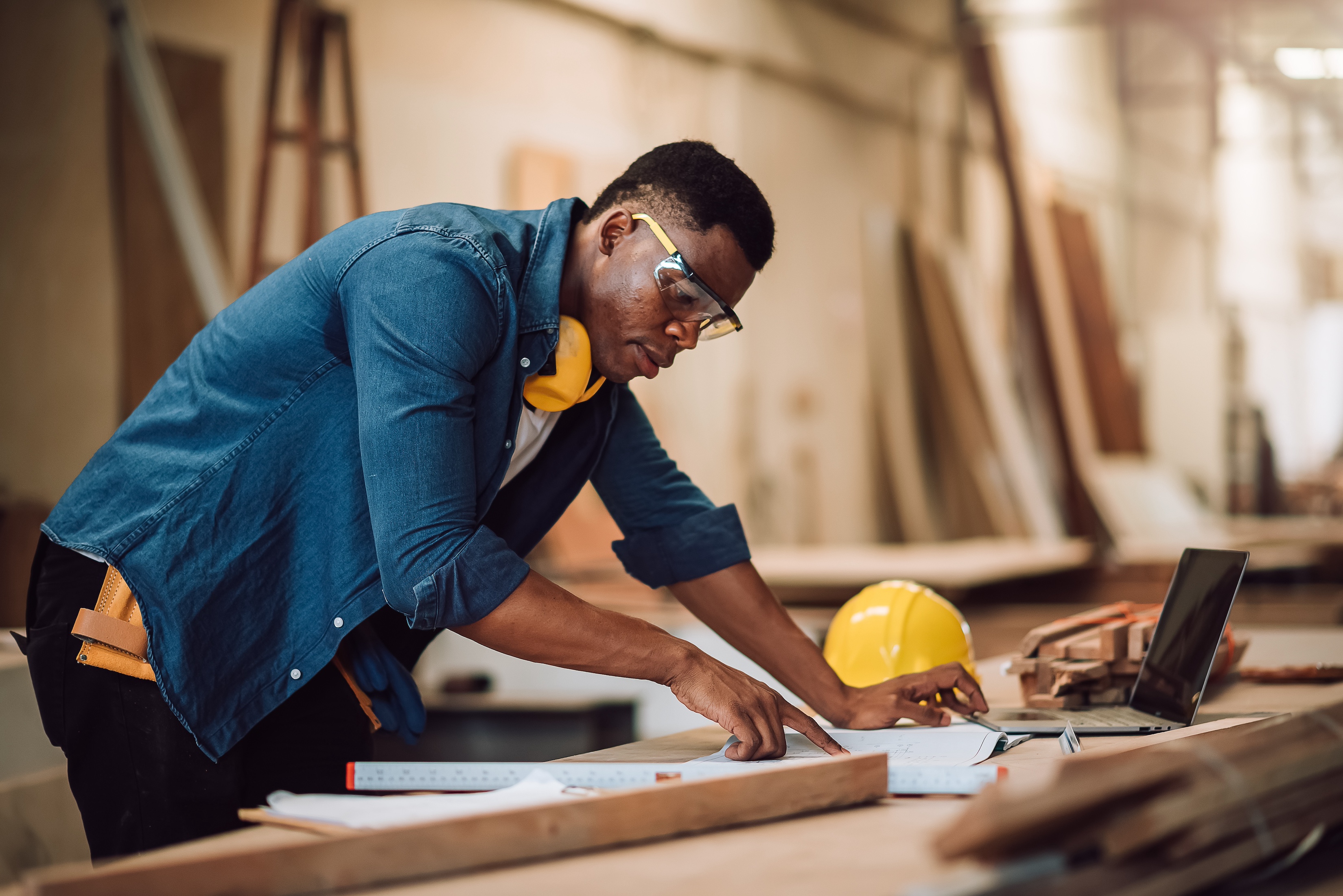 A contractor looks at architectural plans