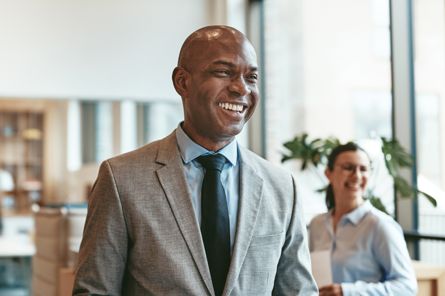 A man in a jacket and tie has been appointed as an officer of a corporation. His duties will include choosing a corporate logo, discussing the business corporation's affairs, attending corporate meetings, shaping company bylaws, overseeing paying taxes, and learning about officers' fiduciary duty and executive compensation. The corporation's financial matters are of utmost importance.