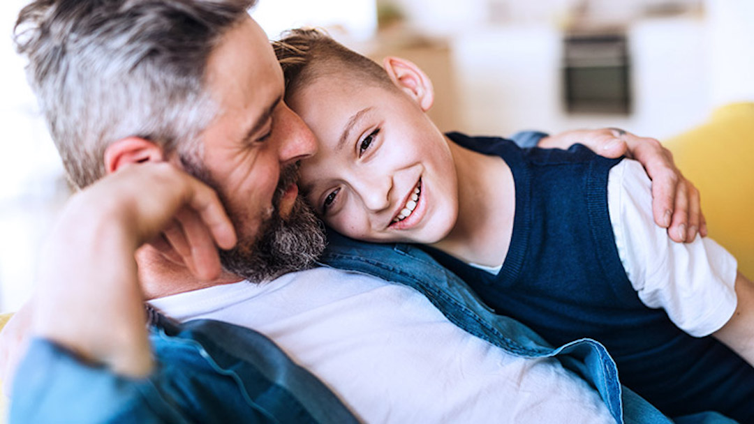 A man seated on a couch hugs his young son, the only heir in the father's last will and testament. A solid understanding of the California probate code is necessary to ensure proper management of your estate after you die..