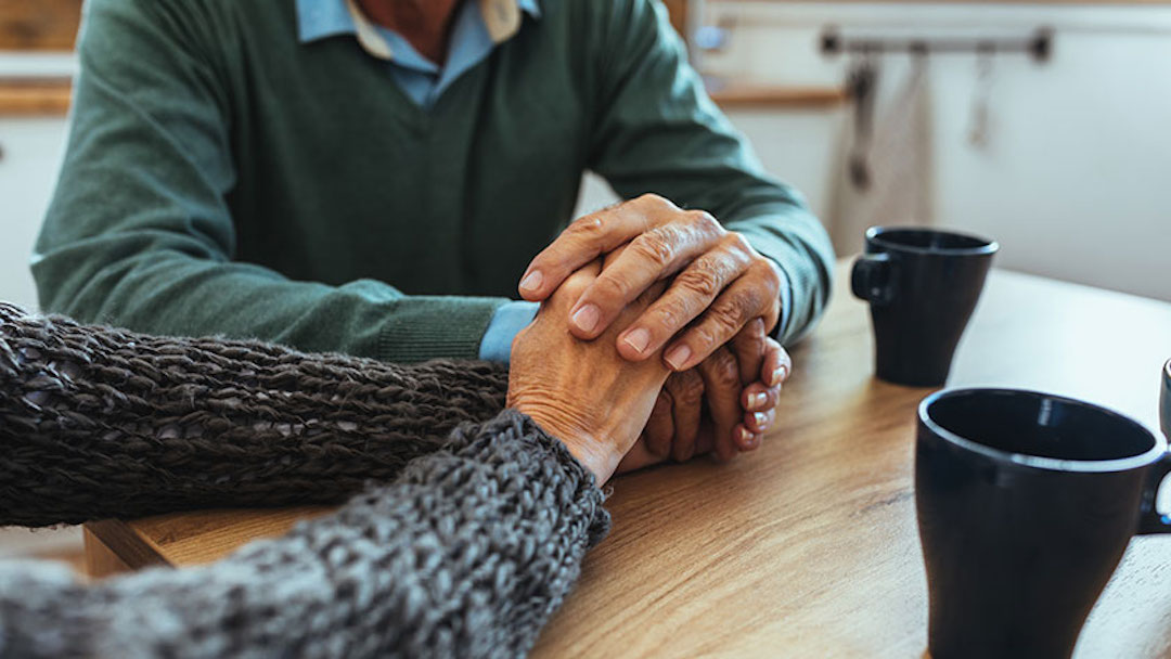 A couple's hands are shown intertwined on a table. While the process may seem daunting, remember that the effort you put into creating a comprehensive will today can provide peace of mind for you and your loved ones in the future. 