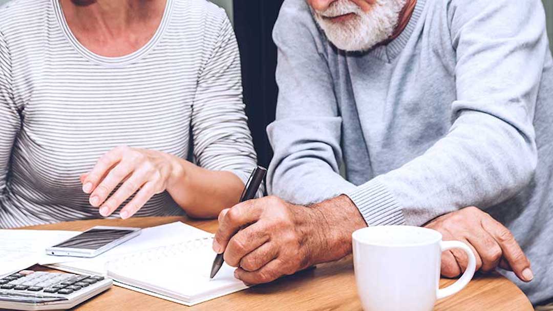 A woman and man seated at a table take notes on estate planning. In Florida, you need to follow specific steps to file your last will and testament for probate within 10 days following your death