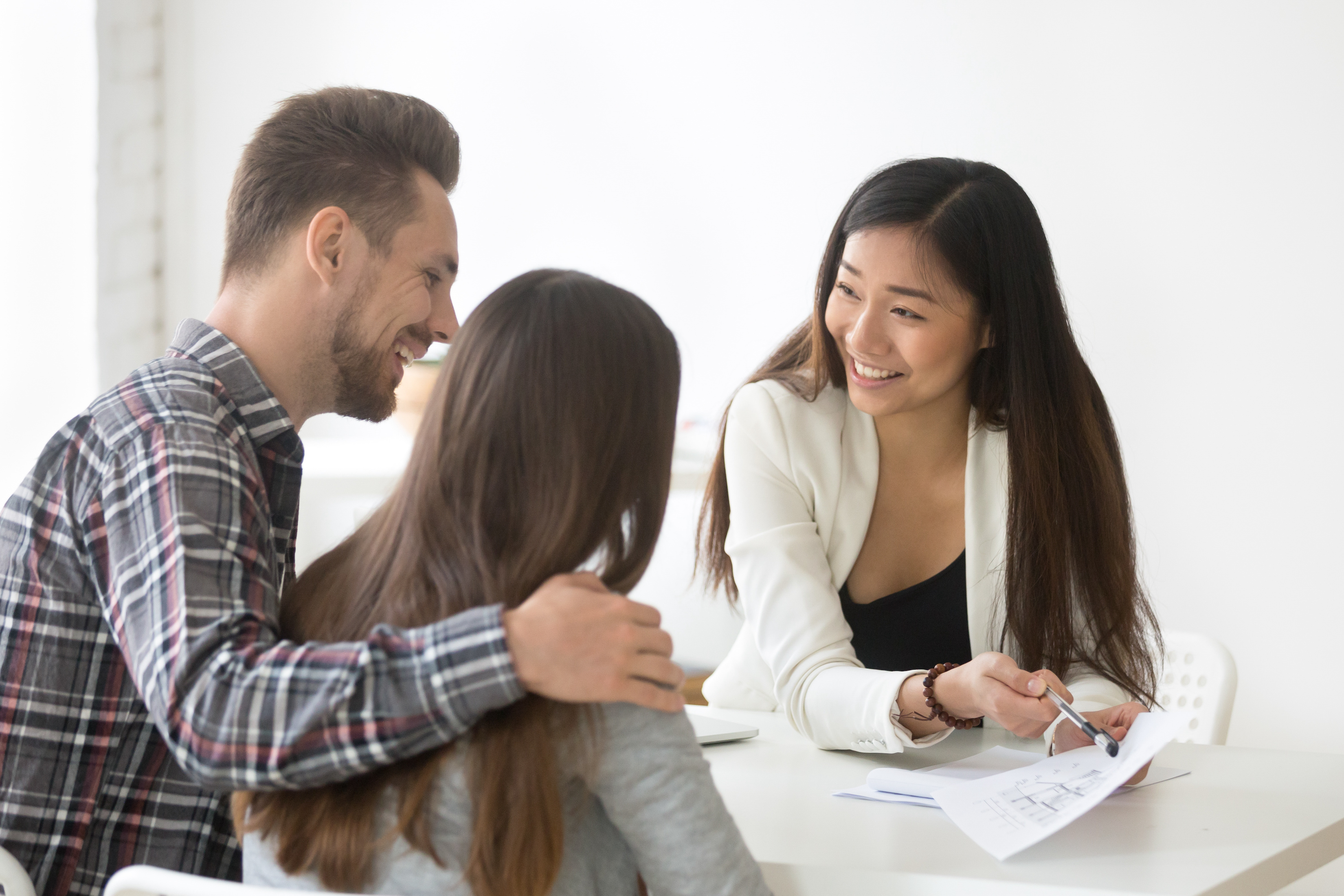 A man puts his arm around a woman as they sit at a desk talking to an estate planning attorney. You can seek assistance from attorneys who are experts in state and federal laws related to wills, trusts, probate, and other aspects of estate planning. 