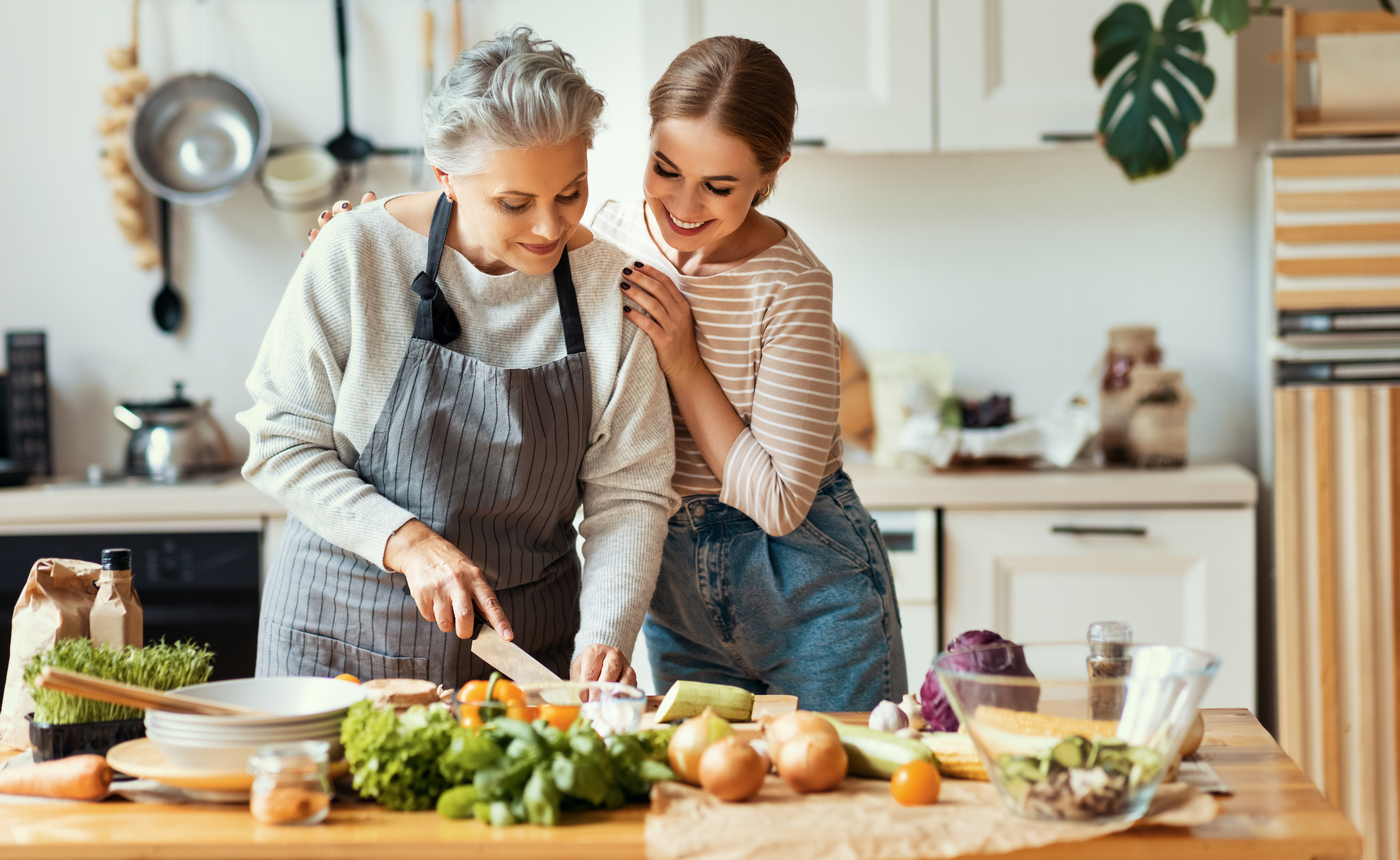 An elderly woman and her friend cook together after the friend agrees to become executor. When selecting an executor, consider their personal qualities and capabilities. 