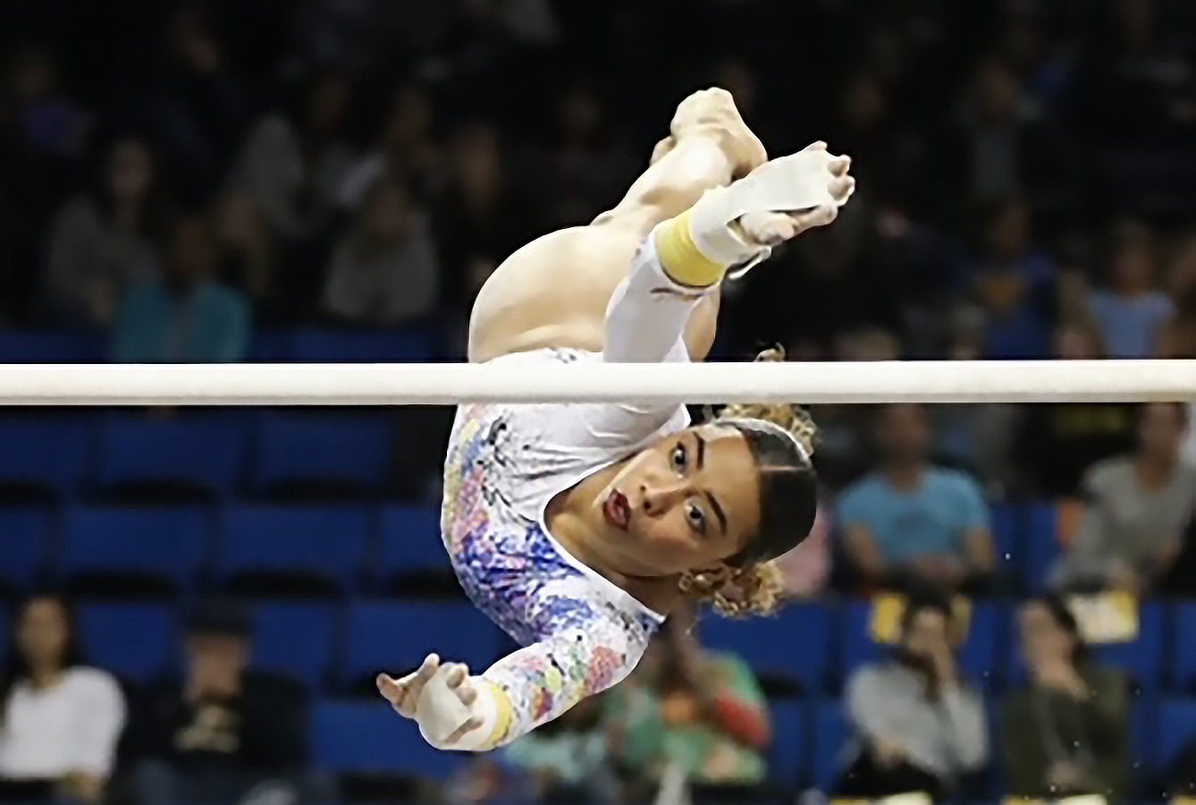 Margzetta Frazier, a gymnast at UCLA, performs on the uneven bars.