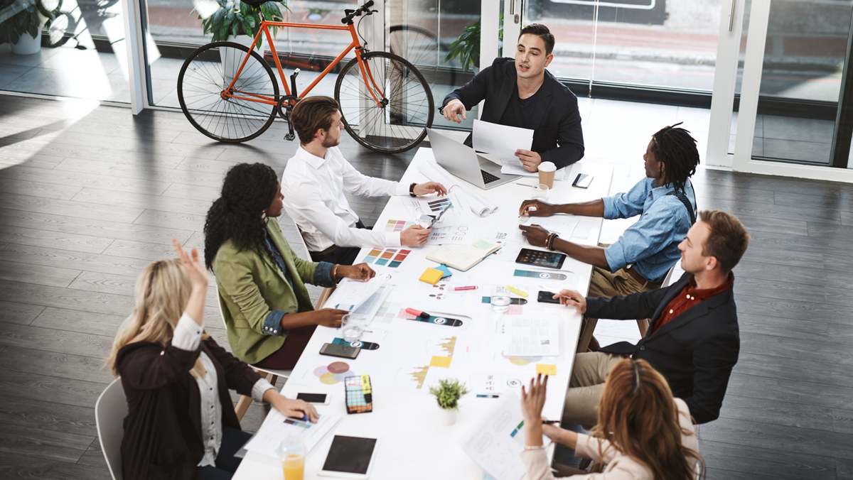 Employees around a table attend a meeting. An employee stock purchase plan, or ESPP, is a program that allows employees to use after-tax payroll deductions to buy their employer's stock.