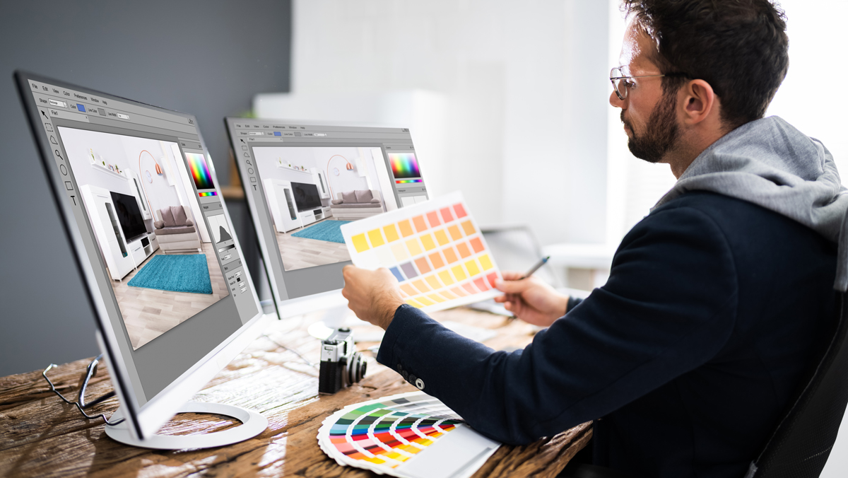 digital artist in studio looking at color swatches before filing his 1099 forms 