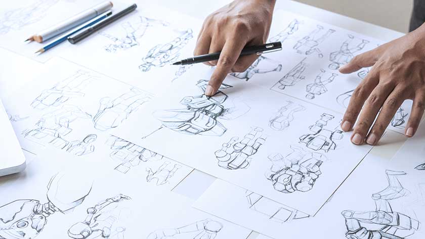 hands-examining-drawings-of-character