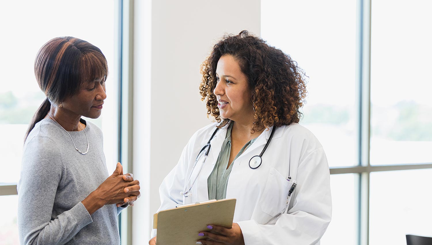 A woman discusses healthcare power of attorney with a doctor.