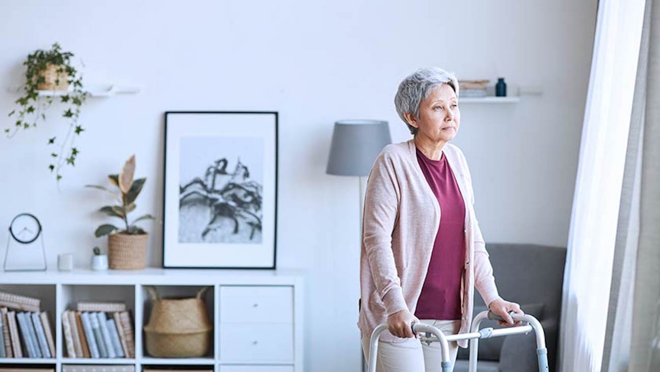 A woman uses a walker inside her home. It's best to update your will after major life events and changes in circumstances.