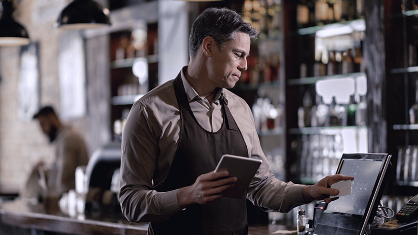 man working register in his store