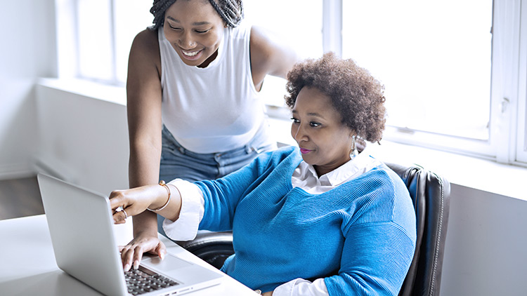 woman looking at computer getting started with their nonprofit application