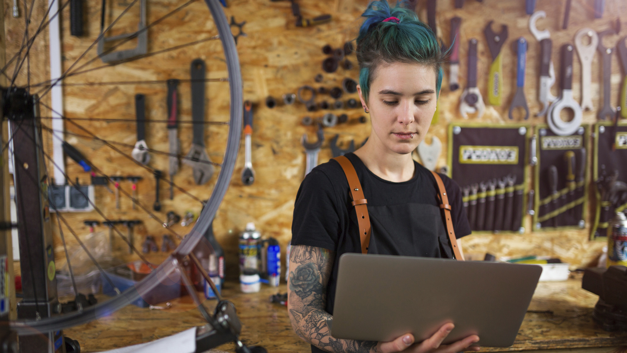 woman on laptop in bike shop