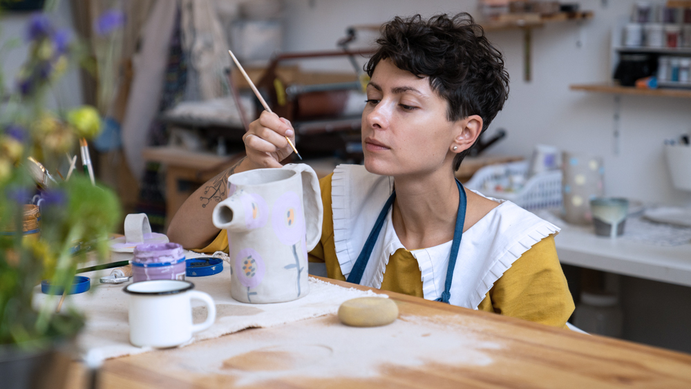 woman painting ceramics