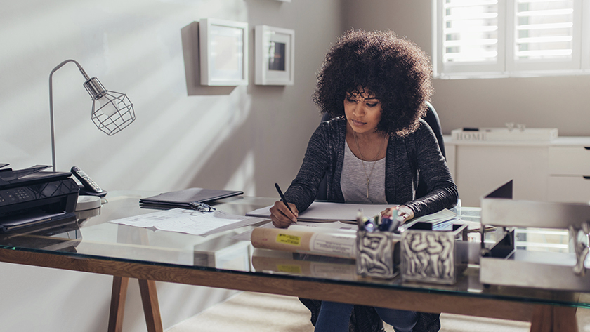 woman sitting at her desk doing her accounting