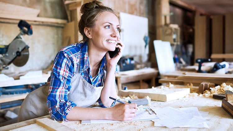 woman talking on the phone in her workshop