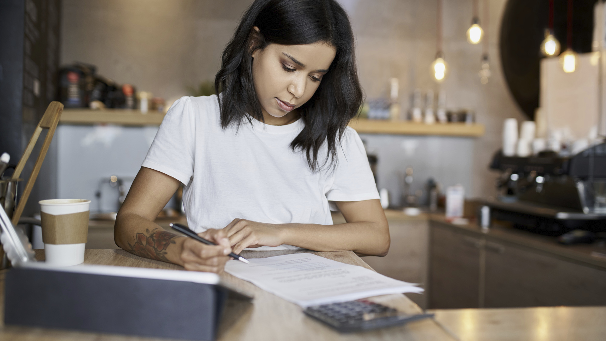 woman with tattoo going over finances 