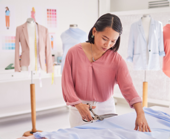 Woman business owner cutting fabric while thinking about her Beneficial Ownership Information Report filing.